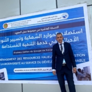Mohamed Lemine in front of banner of aquaculture conference in Mauritania february 2023