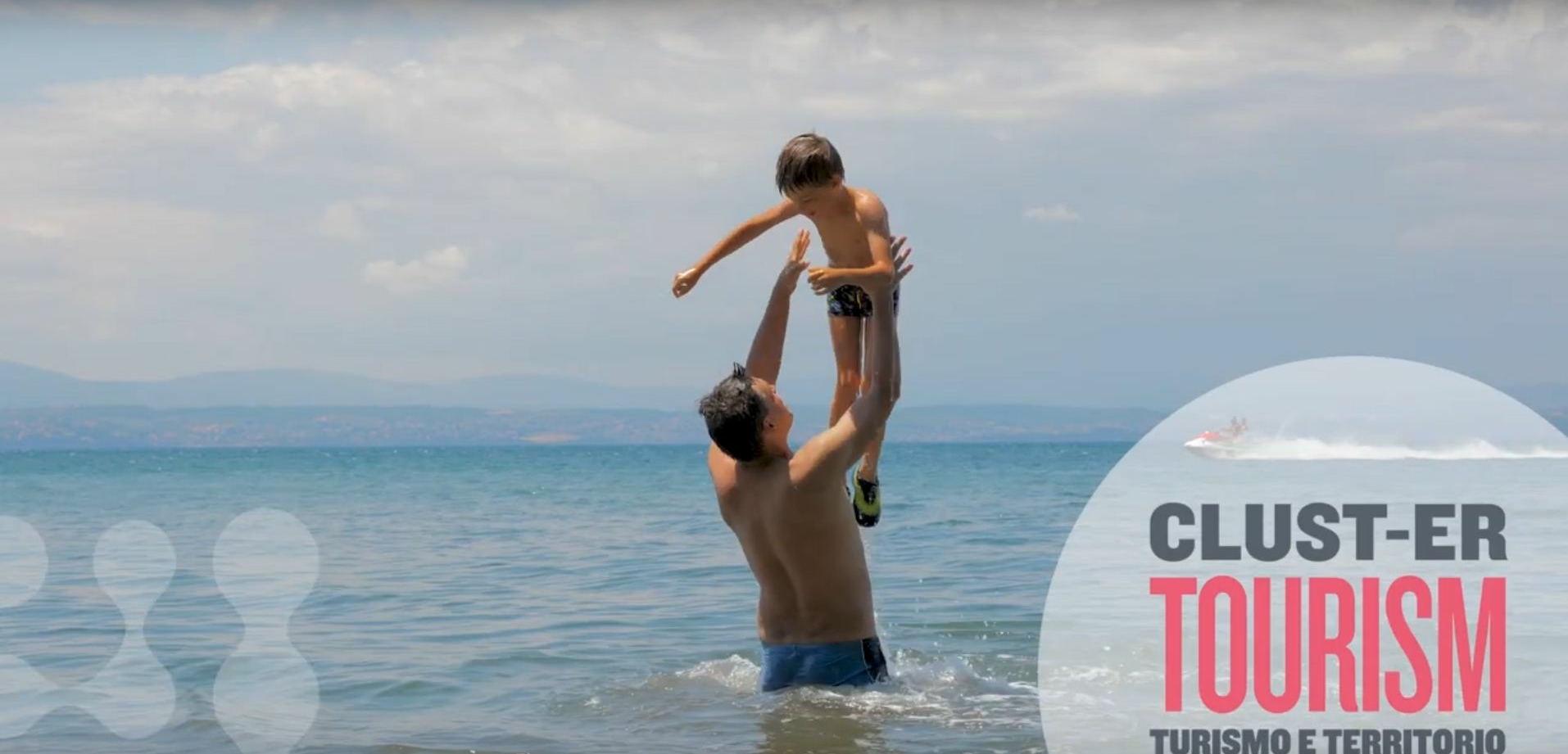 screenshot with man throwing child in the air at the beach in sea