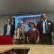 Group of people posing in an office room. decarbonsation meeting