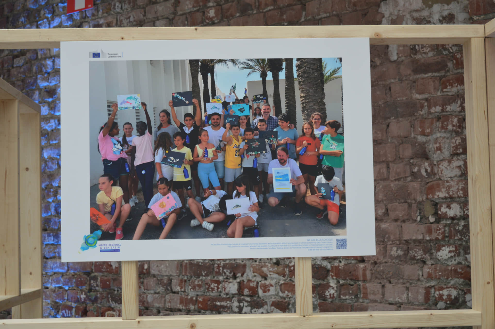 Photo exhibition during macro regional and sea basin strategies days 2024 with photo from the project we are blue schools displaying a group of children