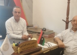 meeting with two people sitting at desk in Libya
