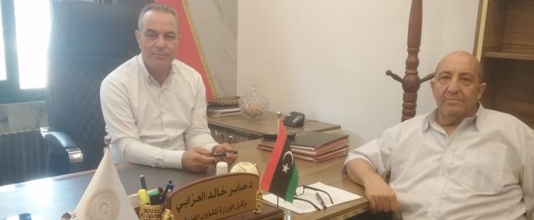 meeting with two people sitting at desk in Libya