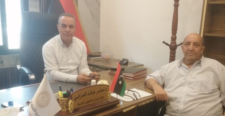 meeting with two people sitting at desk in Libya