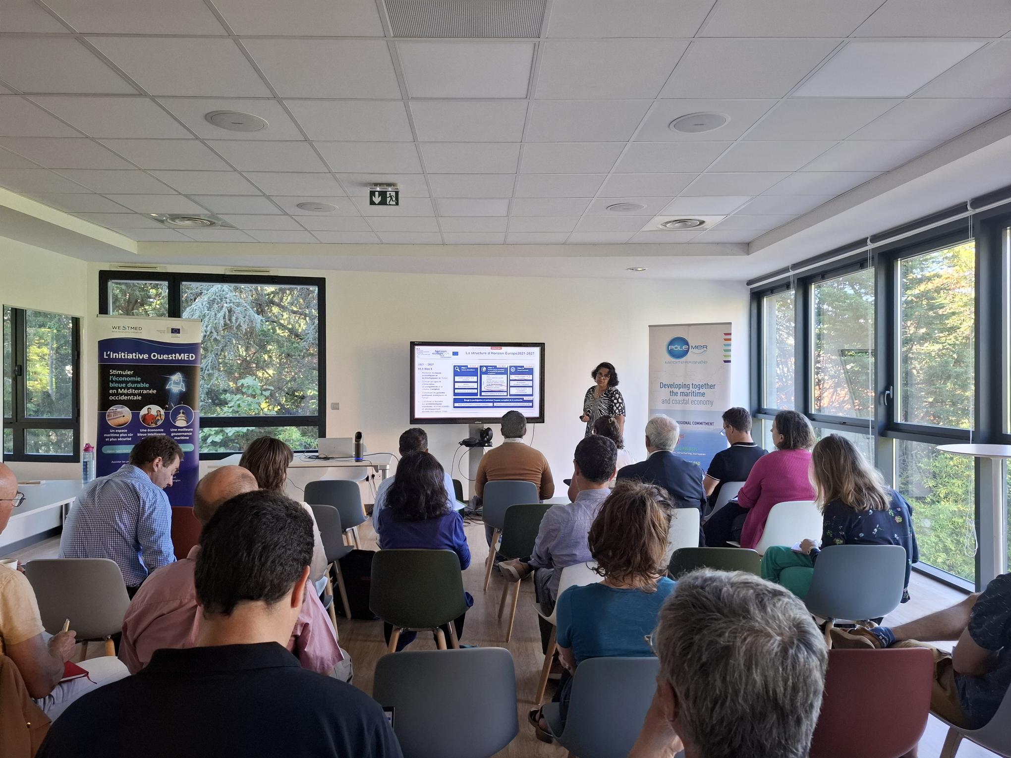 Conference room with people listening to presentation