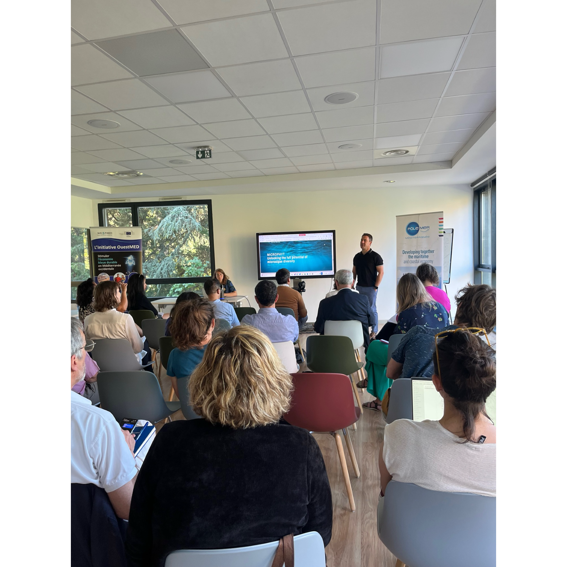Conference room with people listening to presentation
