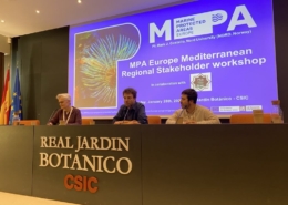 3 people sitting at elevated desk chairing the conference presenting