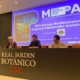 3 people sitting at elevated desk chairing the conference presenting