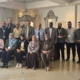Group picture with people posing at workshop