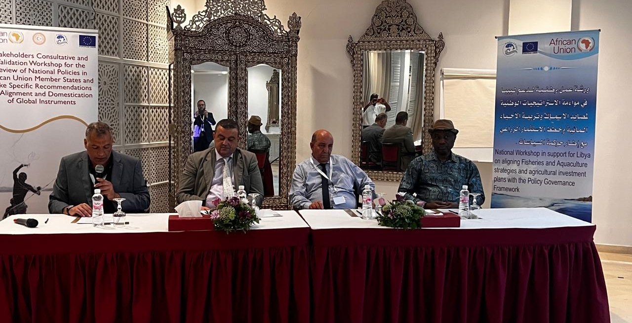 people in a panel discusion, seated at a table