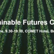 conference announcement poster with a green planted field