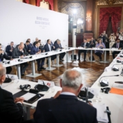 meeting with people seated at table against a United Nations Ocean Conference backdrop