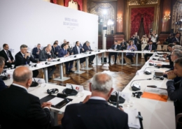 meeting with people seated at table against a United Nations Ocean Conference backdrop