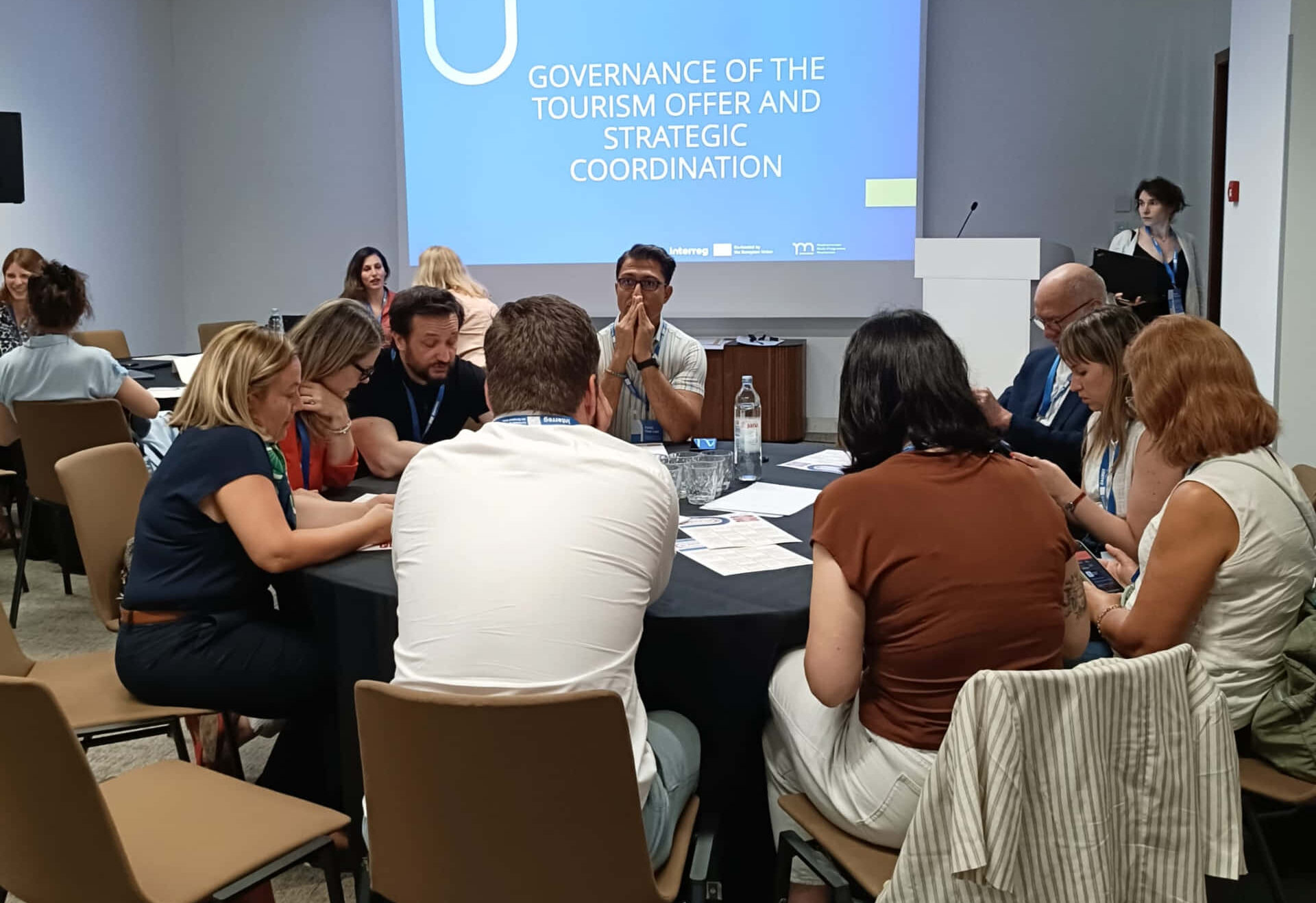 people seated at a round table during workshop at the 2025 Interreg Sustainable Tourism Conference in Split Croatia